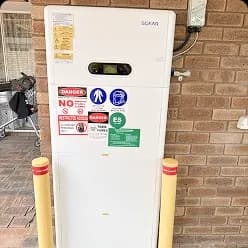 Solar battery with display panel between bollards on a brick wall in Bull Creek, WA