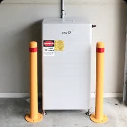 Solar battery guarded by yellow safety bollards in Lowood, QLD
