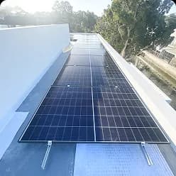 Long row of solar panels along a flat roof in Matraville, NSW
