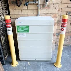 Solar battery guarded by yellow safety bollards in Pagewood, NSW