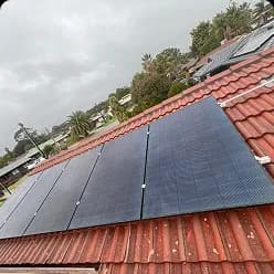 Black solar panels on a terracotta tile roof in Salisbury East, SA