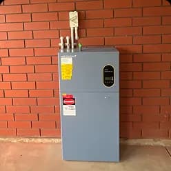 Grey solar battery mounted on a red brick wall in Salisbury East, SA