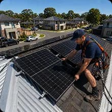 Certified installer fitting solar panels on a roof