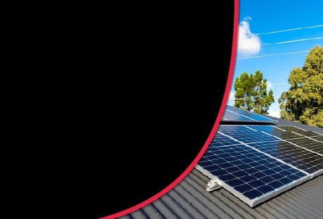 Solar panels on a metal roof with trees in the background, promoting "Solar Panel Shading Solutions" for maximizing energy efficiency