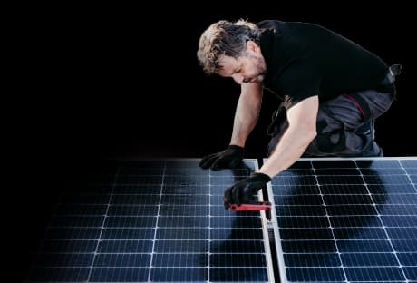 blog banner of technician inspecting rooftop solar panels with text overlay: "Your solar system isn’t performing? Here’s what to check first